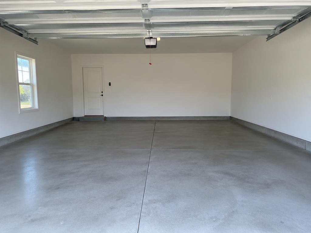 The same garage, completely empty and swept clean